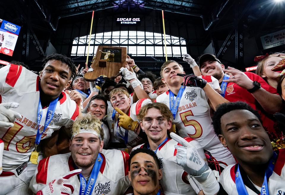 Andrean Fighting 59ers hold up the trophy to celebrate winning the IHSAA Class 2A State Finals on Saturday, Nov. 27, 2021, at Lucas Oil Stadium in Indianapolis.The Andrean Fighting 59ers defeated the Evansville Mater Dei Wildcats, 21-9.