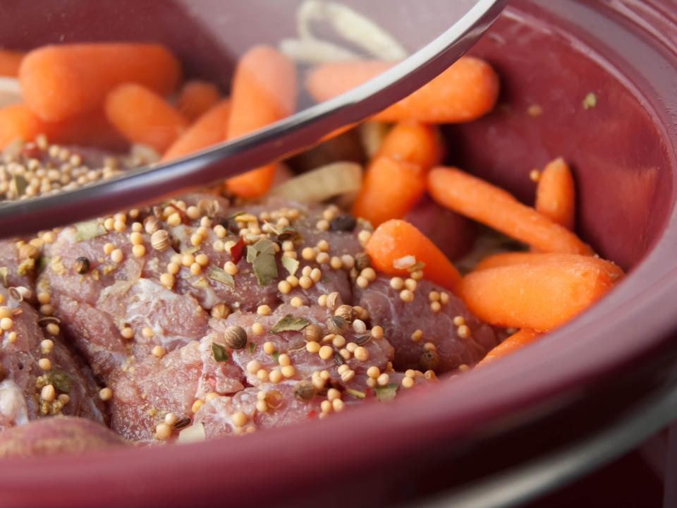 corned beef and carrots cooking in a slow cooker