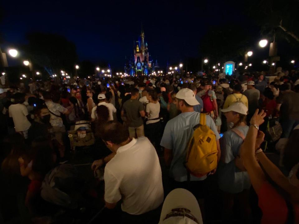 Crowds gather to watch Magic Kingdom's fireworks in August 2021.