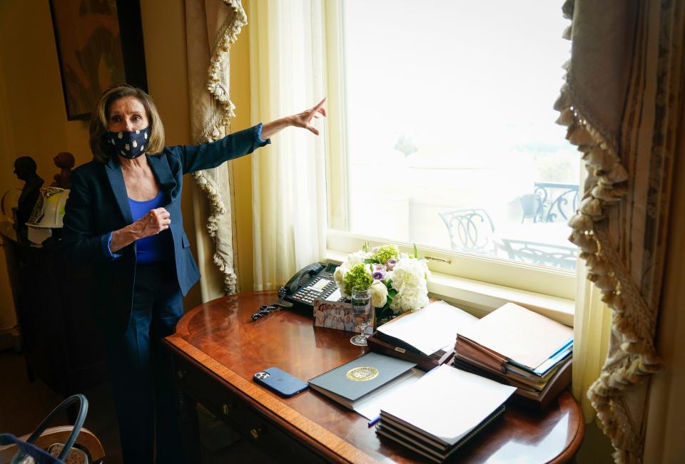 House Speaker Nancy Pelosi, D-Calif., looks out of her Capitol office window at the National Mall on Tuesday.