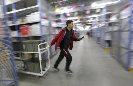 An employee works at a JD.com logistic centre in Langfang, Hebei province, November 10, 2015. REUTERS/Jason Lee