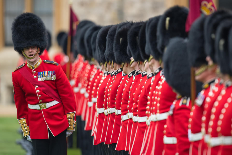 Troops stand to attention at a medal presentation ceremony and parade for the Grenadier Guards at Windsor Castle, Berkshire.