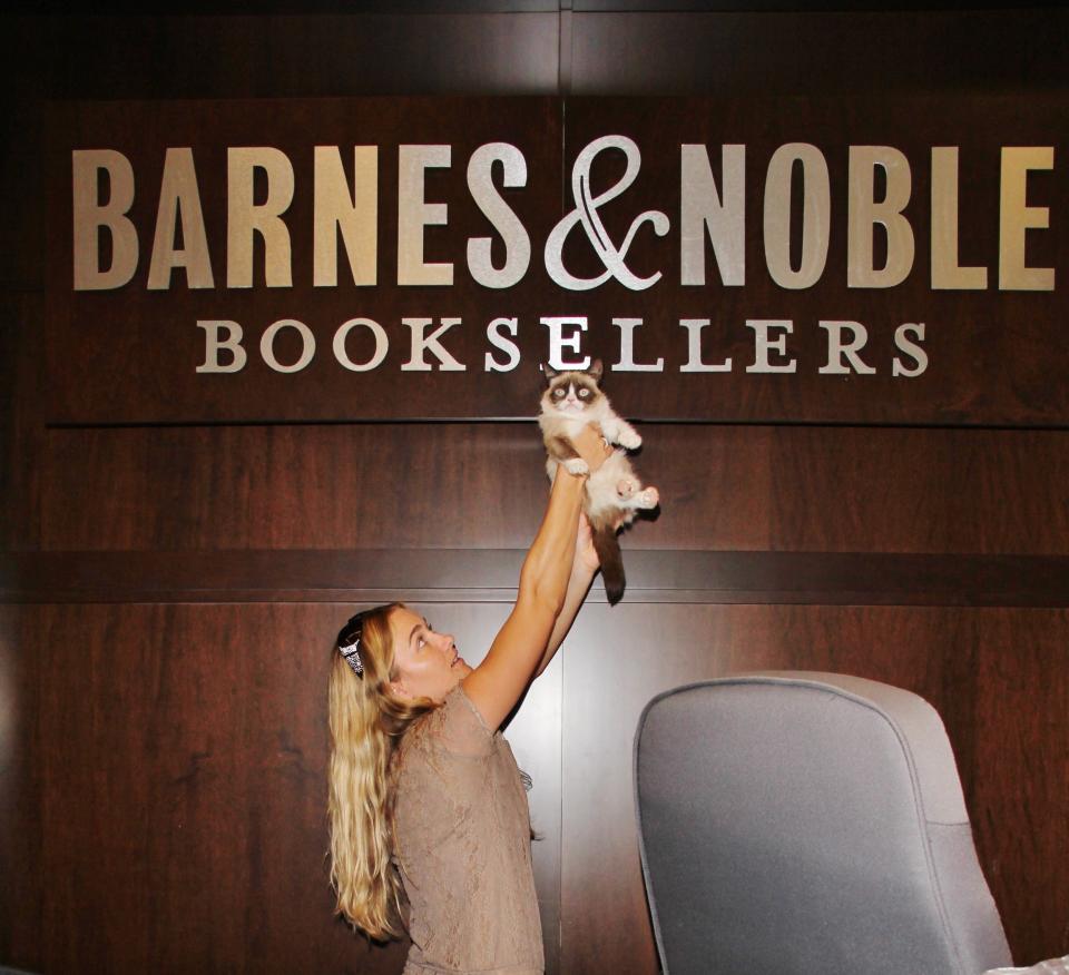 Grumpy Cat does not look impressed at her book signing in Los Angeles. (Credit: AKM-GSI)