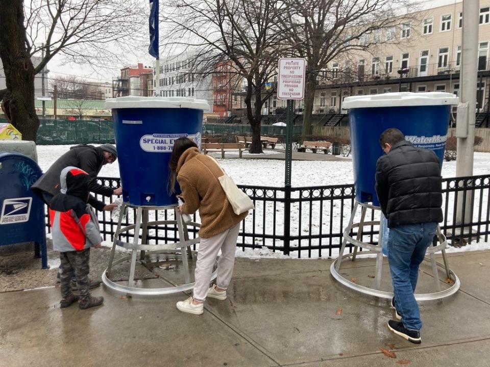 Residents getting free water from a station on Jackson Street in Hoboken on Tuesday. Feb. 28, 2023.
