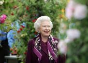 <p>The Queen braves blustery conditions at the annual Chelsea Flower show in May 2006. The rain held off for the 84th RHS show in London, but the weather was windy.</p>