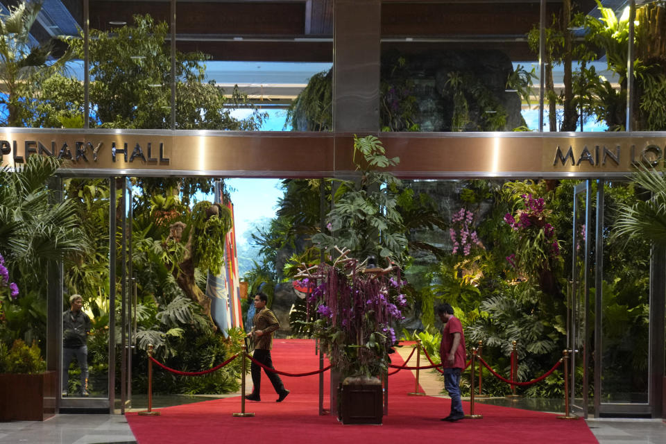 A worker checks the plants used to decorate main lobby of Jakarta Convention Center, the venue for the Southeast Asian Nations (ASEAN) Summit in Jakarta, Indonesia, Monday, Sept. 4, 2023. Indonesian President Joko Widodo will welcome fellow Asian and world leaders with a captivating jungle scene of a two-story waterfall, wild orchids and even an orangutan perched up a tree. (AP Photo/Dita Alangkara)