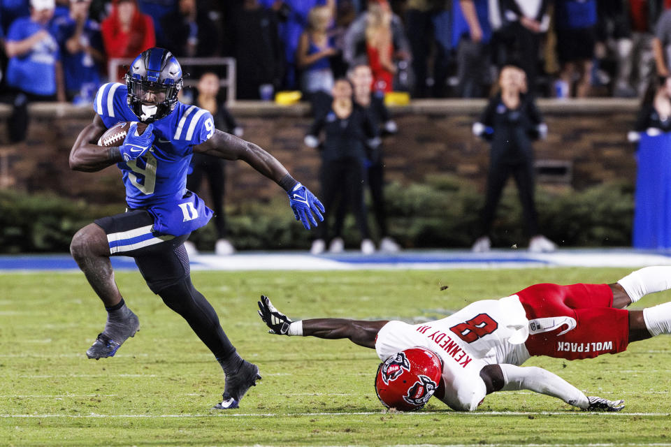 Duke's Jaquez Moore (9) carries the ball past North Carolina State's Robert Kennedy (8) during the second half of an NCAA college football game in Durham, N.C., Saturday, Oct. 14, 2023. (AP Photo/Ben McKeown)