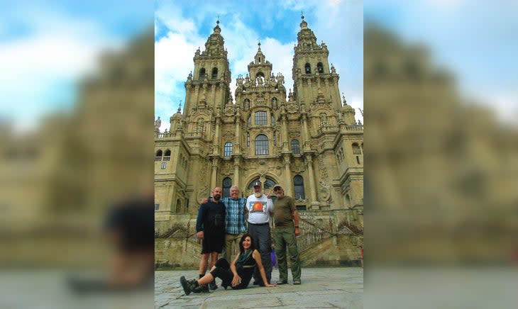 Hikers in front of church on Camino de Santiago