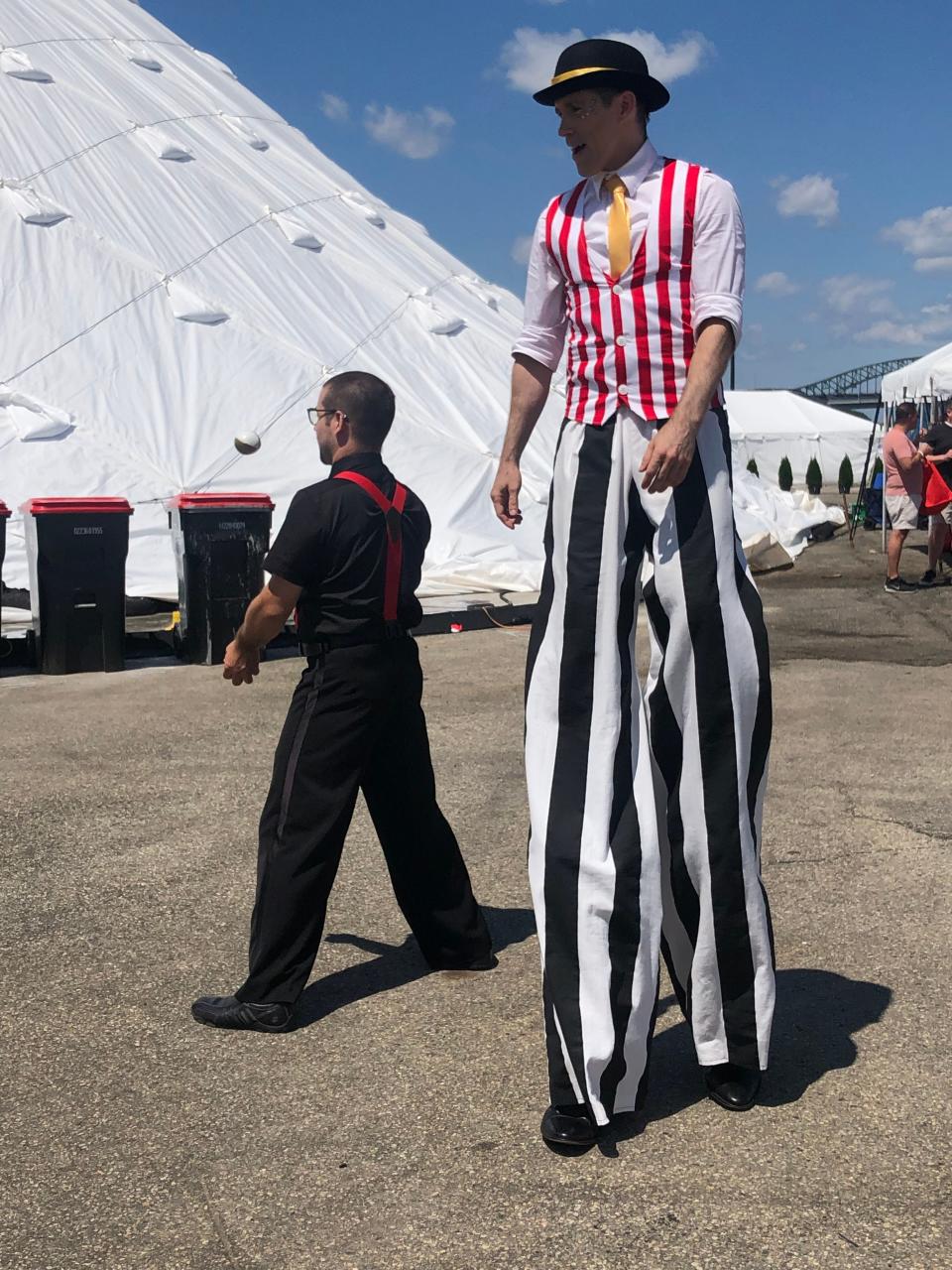 Brightly costumed street performers, clowns and acrobats from the Boston Circus Guild roamed through the open spaces of the Little Italy Carnival in Portsmouth Sunday, Aug. 6, 2023, mingling with the crowd and delighting children and adults with their surprise tricks.