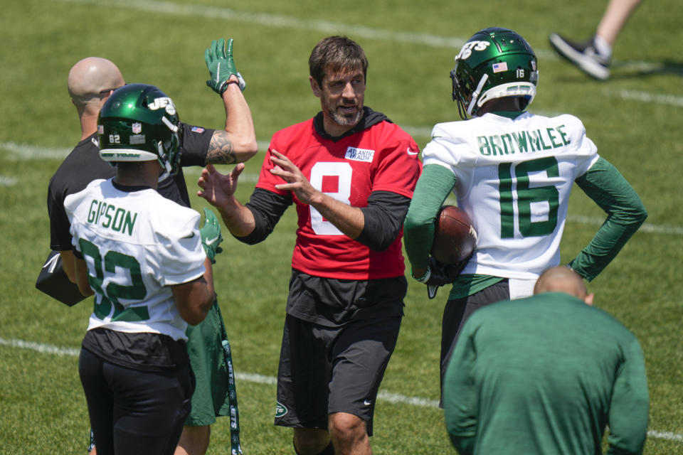 New York Jets quarterback Aaron Rodgers, center, talks to teammates during a drill at NFL football practice at the team's training facility in Florham Park, N.J., Wednesday, May 31, 2023. (AP Photo/Seth Wenig)