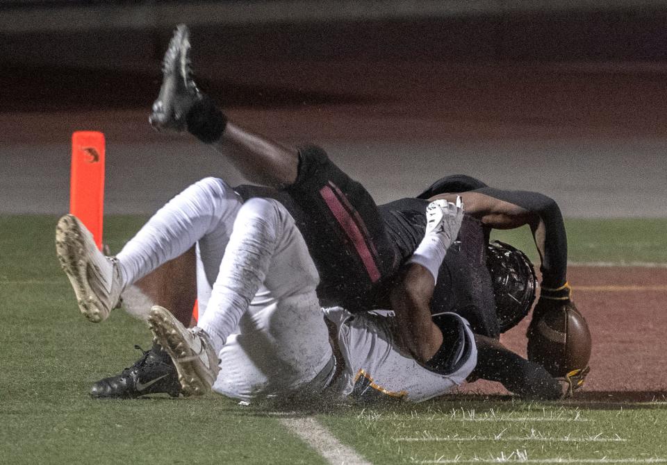Edison's Marcus Harrison, top, stretches over the goal line for a touch down while being tackled by Gregori's Reggieon Foster during Sac-Joaquin Section first round playoff game at Edison's Magnasco Stadium in Stockton on Nov. 3, 2023.