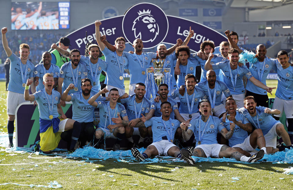 Manchester City players pose with the English Premier League trophy after the English Premier League soccer match between Brighton and Manchester City at the AMEX Stadium in Brighton, England, Sunday, May 12, 2019. Manchester City defeated Brighton 4-1 to win the championship. (AP Photo/Frank Augstein)