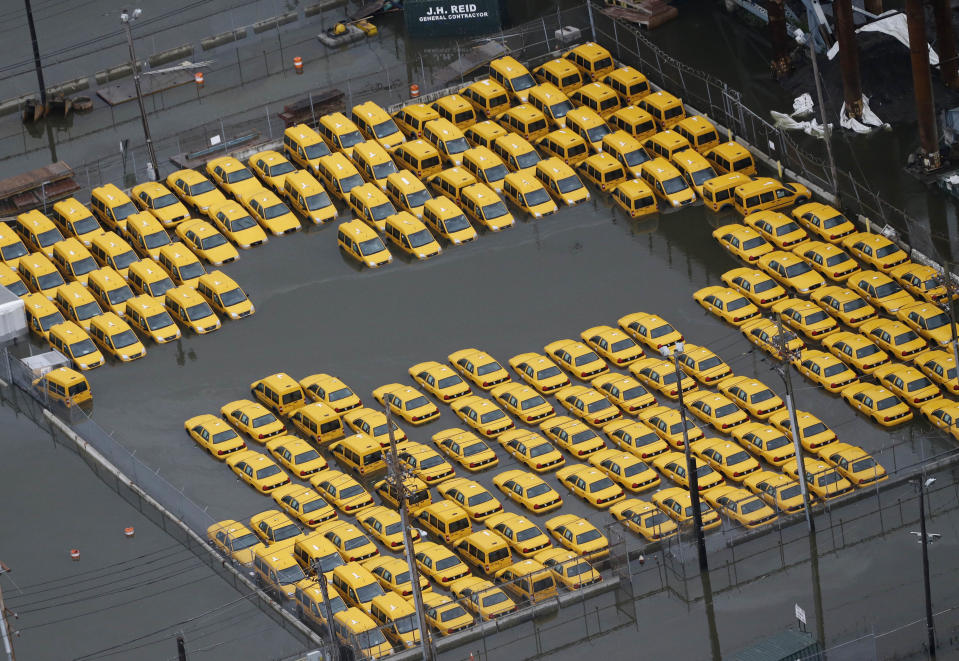 Taxis are submerged in floodwaters in the wake of superstorm Sandy on Tuesday, Oct. 30, 2012, in Weehawken, N.J. Sandy, the storm that made landfall Monday, caused multiple fatalities, halted mass transit and cut power to more than 6 million homes and businesses. (AP Photo/Mike Groll)