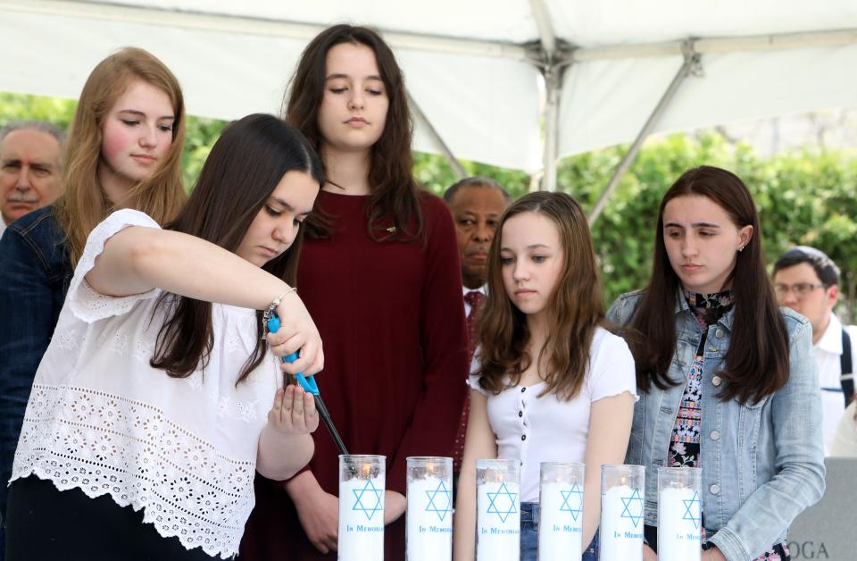 Student award winners from the Somers Holocaust Memorial Commission light candles during the annual Westchester County Yom Hashoah Holocaust Commemoration May 2, 2019 at the Garden of Remembrance in White Plains.