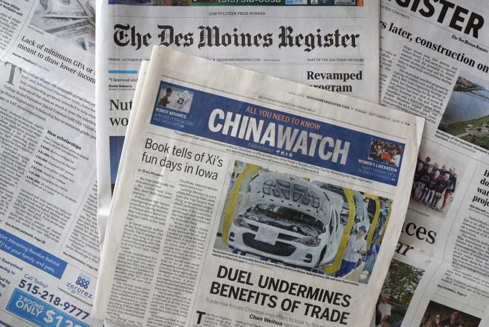 This Friday, Oct. 19, 2018, photo shows a copy of the four-page advertising section Chinawatch along with a copy of The Des Moines Register in Des Moines, Iowa. China's propaganda machine has taken aim at American soybean farmers as part of its high-stakes trade war with the Trump administration. The publication last month of the four-page advertising section in the Register opened a new battle line in China's effort to break the administration's resolve. (AP Photo/Charlie Neibergall)