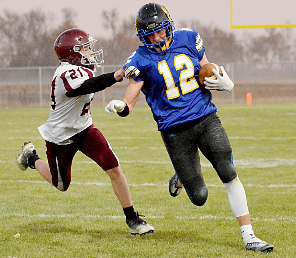 Castlewood's Jackson Schofield runs past Timber Lake's Edward Keller after making a catch during their Class 9A first-round high school football playoff game on Thursday, Oct. 20, 2022 in Castlewood.