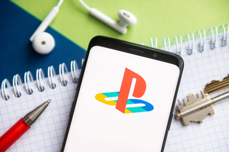 POLAND - 2021/02/09: In this photo illustration, a PlayStation logo seen displayed on a smartphone with a pen, key, book and headsets in the background. (Photo Illustration by Mateusz Slodkowski/SOPA Images/LightRocket via Getty Images)