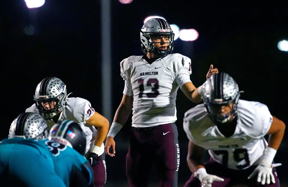 Hamilton quarterback Roch Cholowsky (13) looks to his wideouts against Highland at Highland High School in Gilbert on Sept. 30, 2022.