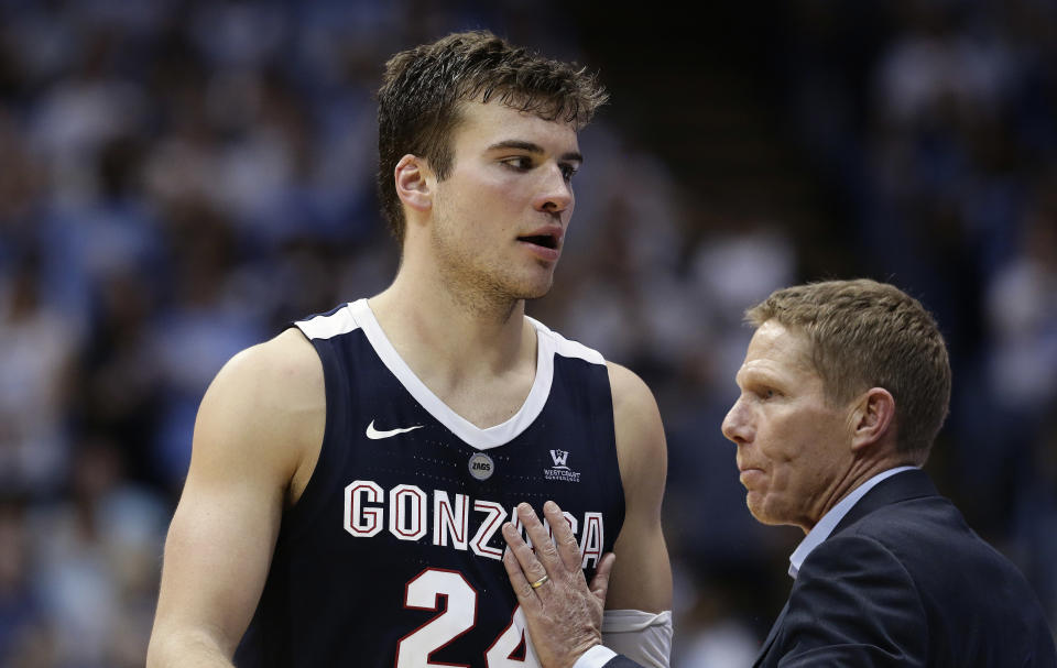 Gonzaga head coach Mark Few puts his hand on Corey Kispert (24) after Kispert fouled out during the second half of an NCAA college basketball game against North Carolina in Chapel Hill, N.C., Saturday, Dec. 15, 2018. North Carolina won 103-90. (AP Photo/Gerry Broome)