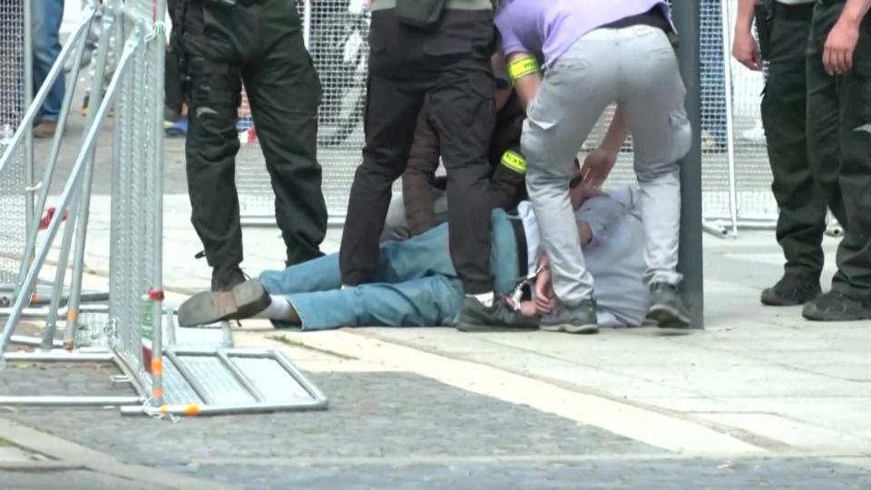 The suspect was detained on the floor (RTVS/AFP via Getty Images)