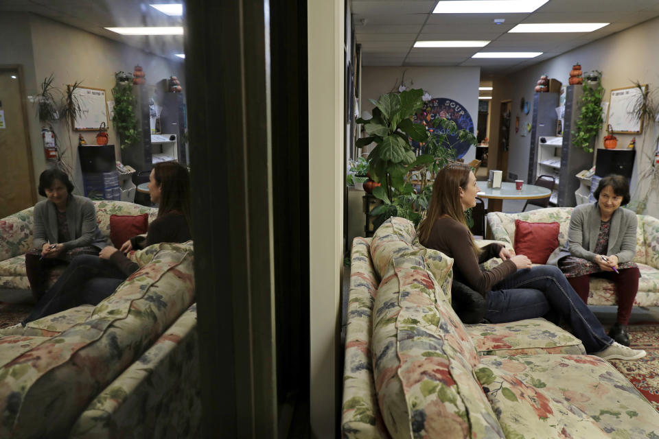 CORRECTS TO CAPITAL, NOT CAPITOL- In this Nov. 14, 2019 photo, Jamie Cline, second from right, talks with Dr. Lucinda Grande, right, medical director of the Olympia Bupe Clinic at the Capital Recovery Center, in Olympia, Wash., which helps people addicted to heroin and other opiates get prescriptions for buprenorphine, a medicine that prevents withdrawal sickness. At the clinic, Grande is working to spread a philosophy called "medication first," which scraps requirements for counseling, abstinence or even a commitment to recovery in the battle against opioid addiction. (AP Photo/Ted S. Warren)