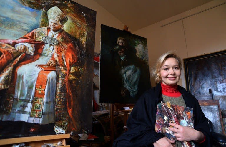 Natalia Tsarkova next to a painting of Pope Benedict XVI on December 18, 2012 in her studio. Tsarkova, the Vatican's latest official painter. arrived in Rome in the early 1990s and began doing portraits of Roman aristocrats, who introduced her at the Vatican, where her background captured the attention of late pope John Paul II