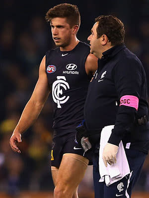 Marc Murphy of the Blues is helped from the ground after colliding with Luke Hodge of the Hawks during the round 12 AFL match between the Carlton Blues and the Hawthorn Hawks at Etihad Stadium on June 14, 2013 in Melbourne, Australia.