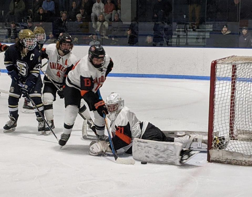 Gardner/Murdock goaltender Mark Quinn receives help from defenseman Ray Thomas after making a left-leg pad save during the second period of a Central Mass. Class C semifinal against St. Bernard's, Wednesday, at Veterans Arena in Gardner.