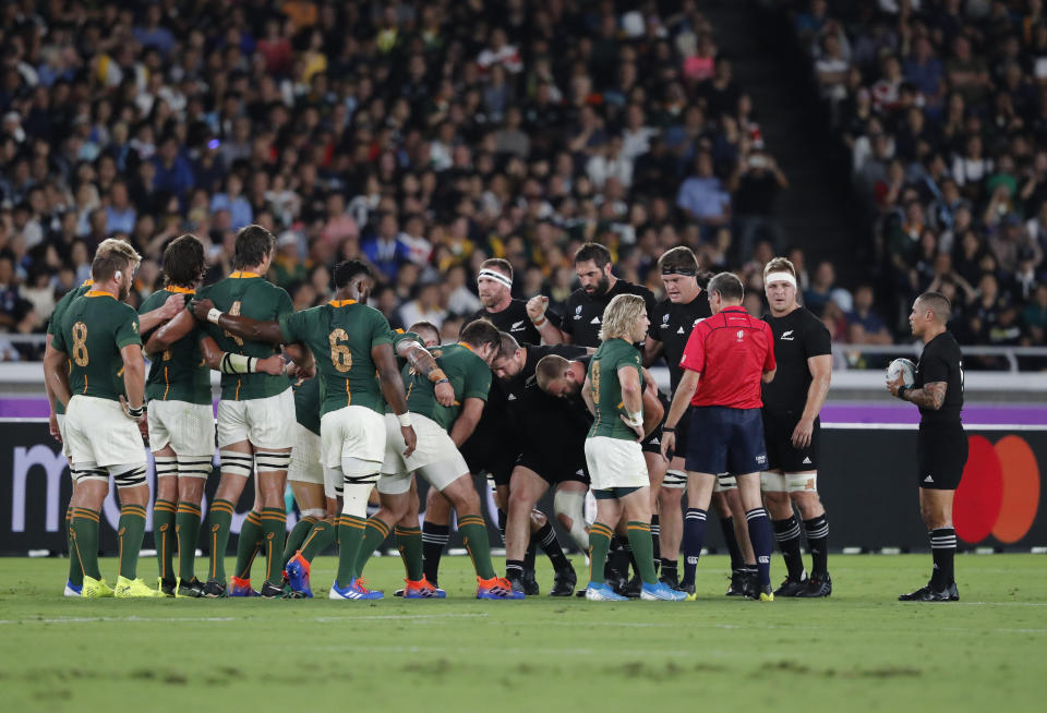 New Zealand and South African teams prepare for a scrum fight during the Rugby World Cup Pool B game between New Zealand and South Africa in Yokohama, Japan, Saturday, Sept. 21, 2019. (AP Photo/Shuji Kajiyama)