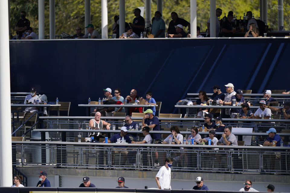 Fans watch during the fourth inning of a spring baseball game between the New York Yankees and the Toronto Blue Jays Sunday, Feb. 28, 2021, in Tampa, Fla. (AP Photo/Frank Franklin II)