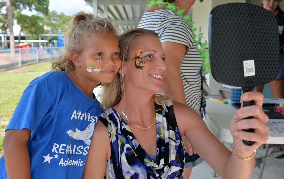 Alta Vista second grader Naomi Quamina, 6, and her mom, Adrianne Luetzow, get their faces painted together July 21 at the Alta Vista Eagle Fest, a family celebration and cookout to celebrate the school’s summer Eagle Academy.