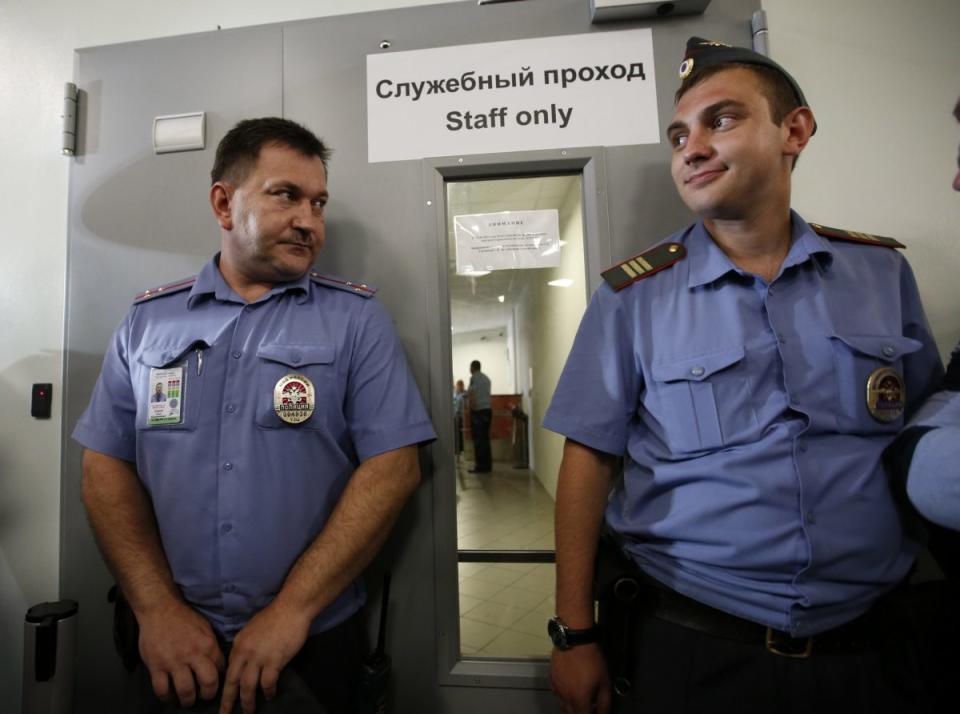 Police guard a door where human rights groups were taken to meet Snowden at Sheremetyevo airport July 12, 2013. REUTERS/Grigory Dukor