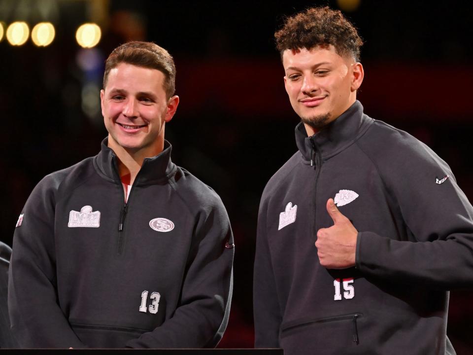 Brock Purdy of the San Francisco 49ers (L) and Patrick Mahomes of the Kansas City Chiefs stand on stage during Super Bowl LVIII Opening Night at Allegiant Stadium on February 05, 2024 in Las Vegas, Nevada