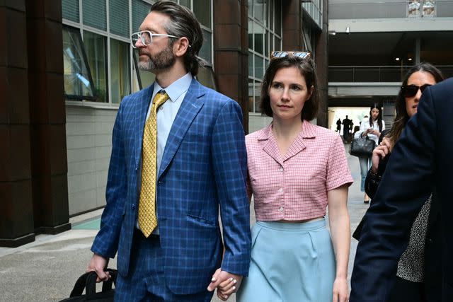 <p>TIZIANA FABI/AFP via Getty</p> Amanda Knox and her husband Christopher Robinson