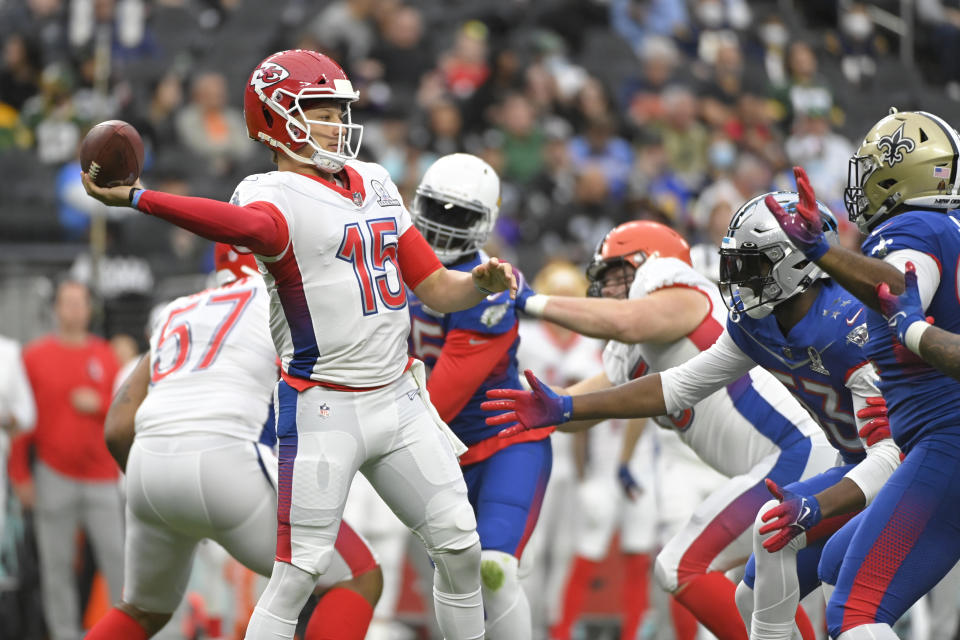 FILE - AFC quarterback Patrick Mahomes (15), of the Kansas City Chiefs passes against the NFC during the first half of the Pro Bowl NFL football game, Sunday, Feb. 6, 2022, in Las Vegas. The NFL is replacing the Pro Bowl with weeklong skills competitions and a flag football game. The new event will be renamed “The Pro Bowl Games” and will feature AFC and NFC players showcasing their football and non-football skills in challenges over several days. (AP Photo/David Becker, File )