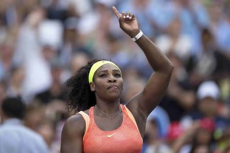 Serena Williams of the U.S. makes a sign towards fans after defeating compatriot Madison Keys in their fourth round match at the U.S. Open Championships tennis tournament in New York, September 6, 2015. REUTERS/Carlo Allegri