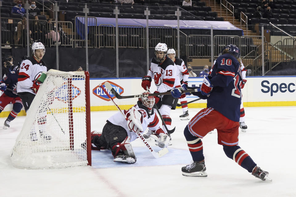 New York Rangers' Artemi Panarin (10) scores in the second period against New Jersey Devils' Mackenzie Blackwood (29) during an NHL hockey game Thursday, April 15, 2021, in New York. (Bruce Bennett/Pool Photo via AP)