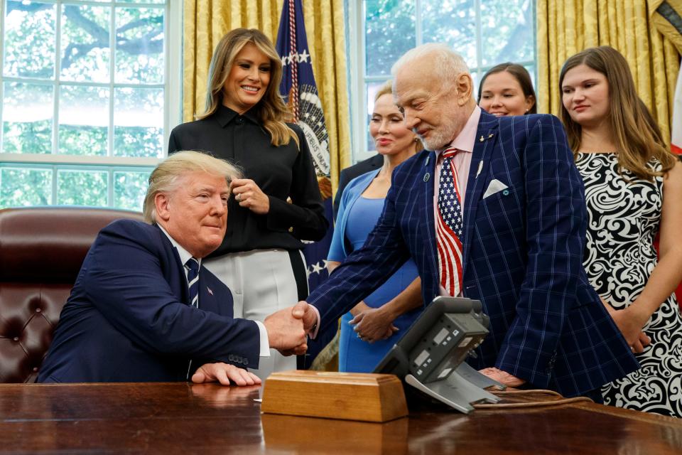 President Donald Trump shakes hands with Apollo 11 astronaut Buzz Aldrin during a photo op commemorating the 50th anniversary of the Apollo 11 moon landing, in the Oval Office of the White House, Friday, July 19, 2019, in Washington, D.C.