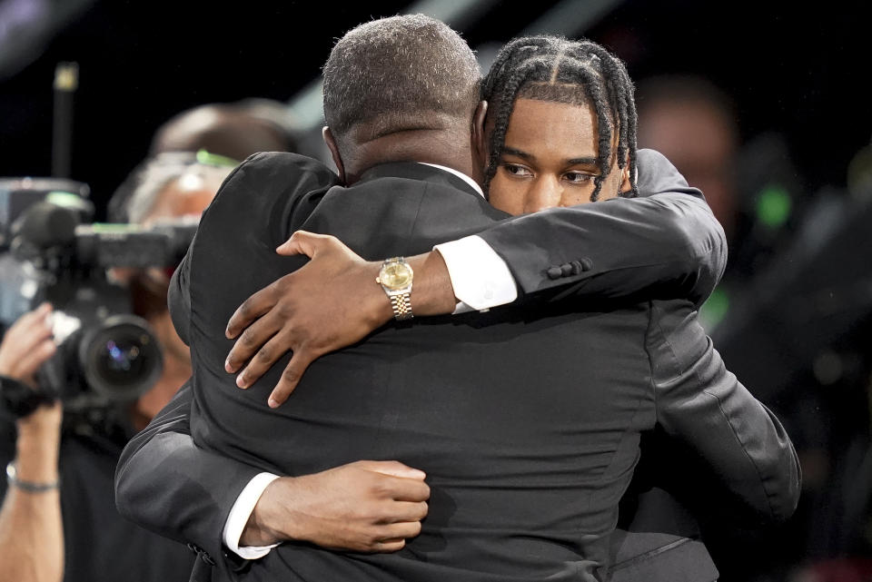 Blake Wesley, right, hugs family and friends after being selected 25th overall by the San Antonio Spurs in the NBA basketball draft, Thursday, June 23, 2022, in New York. (AP Photo/John Minchillo)