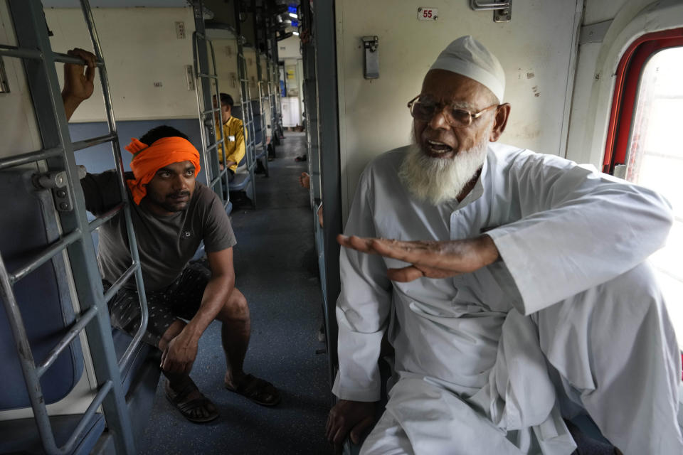 Haji Abdul Subhan, a 74-year-old former railway employee, speaks while travelling in the Thirukkural Express, Saturday, April 20, 2024. (AP Photo/Manish Swarup)