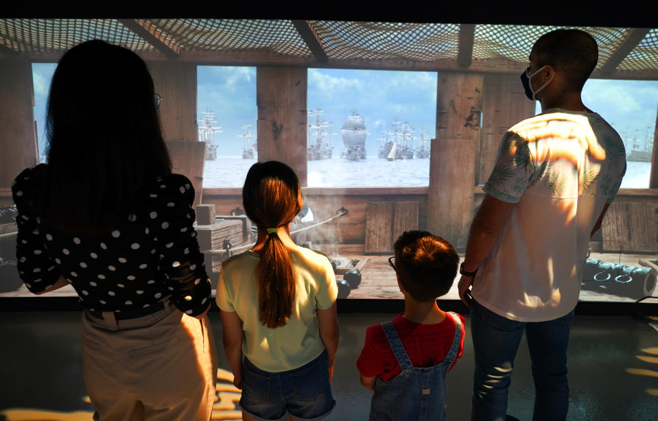 <p>A family watch a preview of the new 1545 experience at The Mary Rose exhibition at Portsmouth Historic Dockyard. Picture date: Wednesday July 14, 2021.</p>
