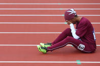 LONDON, ENGLAND - AUGUST 03: Noor Hussain Al-Malki of Qatar pulls up injured in the Women's 100m Heats on Day 7 of the London 2012 Olympic Games at Olympic Stadium on August 3, 2012 in London, England. (Photo by Alexander Hassenstein/Getty Images)