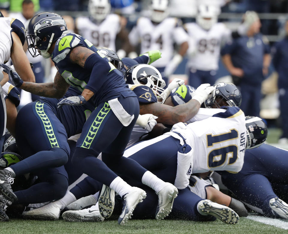 Los Angeles Rams quarterback Jared Goff (16) keeps the ball for a fourth down conversion late in the fourth quarter of an NFL football game against the Seattle Seahawks, Sunday, Oct. 7, 2018, in Seattle. (AP Photo/Elaine Thompson)