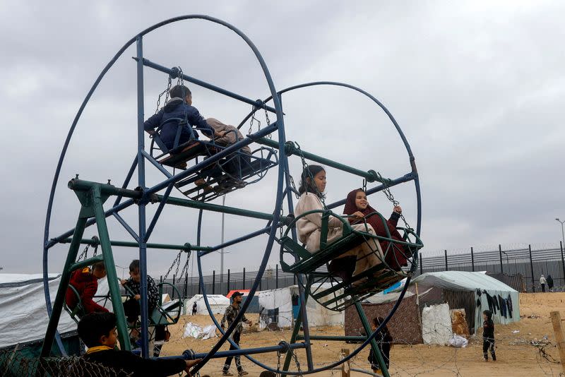 FILE PHOTO: Displaced Palestinians shelter at a tent camp at the border with Egypt, in Rafah in the southern Gaza Strip
