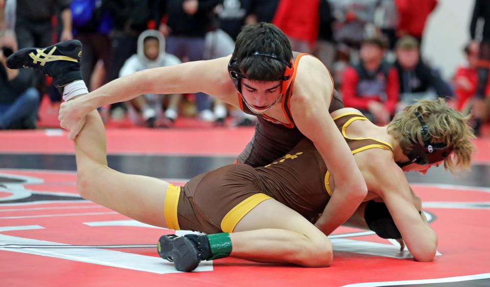 Blake Bartos of Buckeye, top, wrestles Bronson Begley of Alter during their 113 pound match in the finals of the Wadsworth Grizzly Invitational Tournament, Saturday, Jan. 20, 2024, in Wadsworth, Ohio.