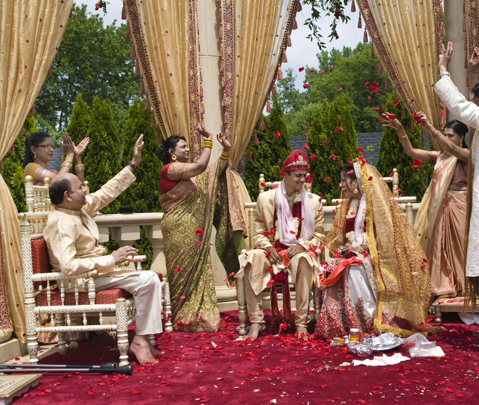 Indian family celebrating a bride and groom in a traditional Hindu ceremony