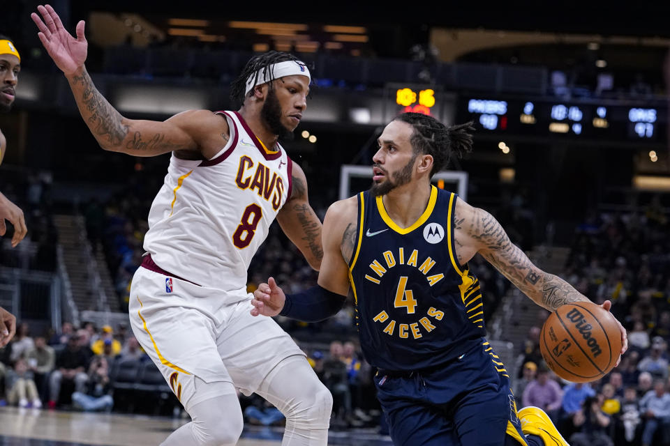 Indiana Pacers guard Duane Washington Jr. (4) drives on Cleveland Cavaliers forward Lamar Stevens (8) during the second half of an NBA basketball game in Indianapolis, Tuesday, March 8, 2022. The Cavaliers won 127-124. (AP Photo/Michael Conroy)