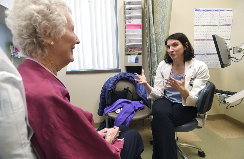 In this Monday, March 4, 2019 photo, Dr. Allison Magnuson, Geriatric Oncology and Breast Oncology at Wilmot Cancer Institute, right, speaks with patient Nancy Simpson at the Pluta Cancer Center in Rochester, N.Y. Instead of assuming that elderly patients are too frail for treatment or recommending harsh drugs tested only in younger patients, cancer doctors are taking time to evaluate their physical and mental fitness, along with emotional and social well-being. (AP Photo/Adrian Kraus)