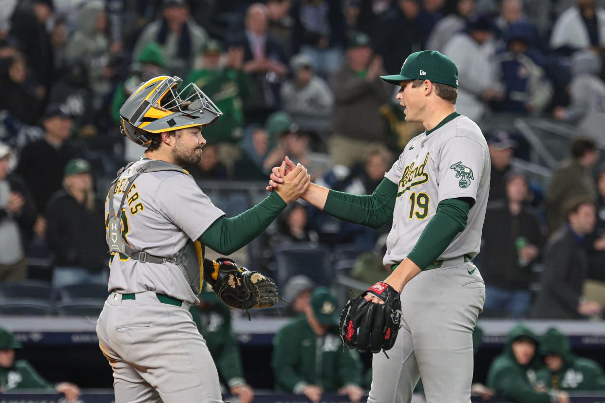 Apr 25, 2024; Bronx, New York, USA; Oakland Athletics relief pitcher Mason Miller (19) celebrates with catcher Shea Langeliers (23) after defeating the New York Yankees at Yankee Stadium. Mandatory Credit: Vincent Carchietta-USA TODAY Sports