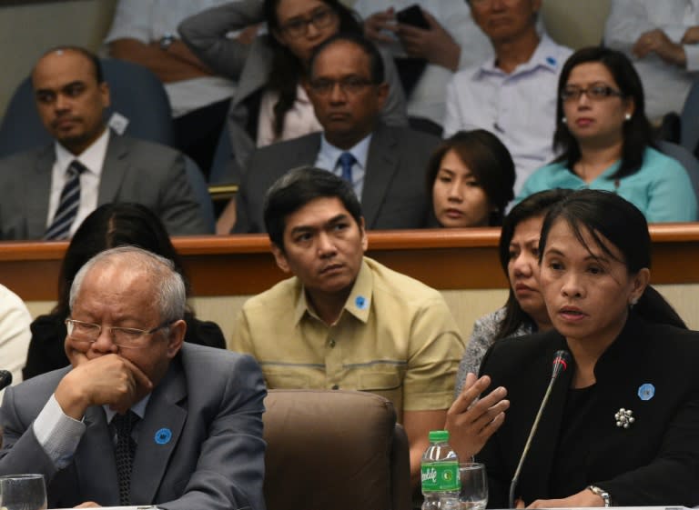 Julia Abad (R), deputy director of the anti-money laundering council, speaks at a senate hearing in Manila on March 17, 2016